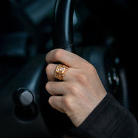 Thumbnail for Men's 0.61ctw diamond 18k yellow gold ornate signet ring on hand holding steering wheel