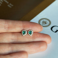 Thumbnail for 0.56ctw natural alexandrite 18k white gold stud earrings with diamond jackets displayed on hand.
