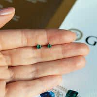 Thumbnail for 0.56ctw natural alexandrite 18k white gold stud earrings with diamond jackets held in hand.