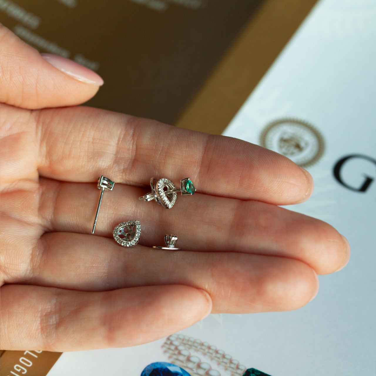 18k white gold stud earrings with natural alexandrite and diamond jackets.
