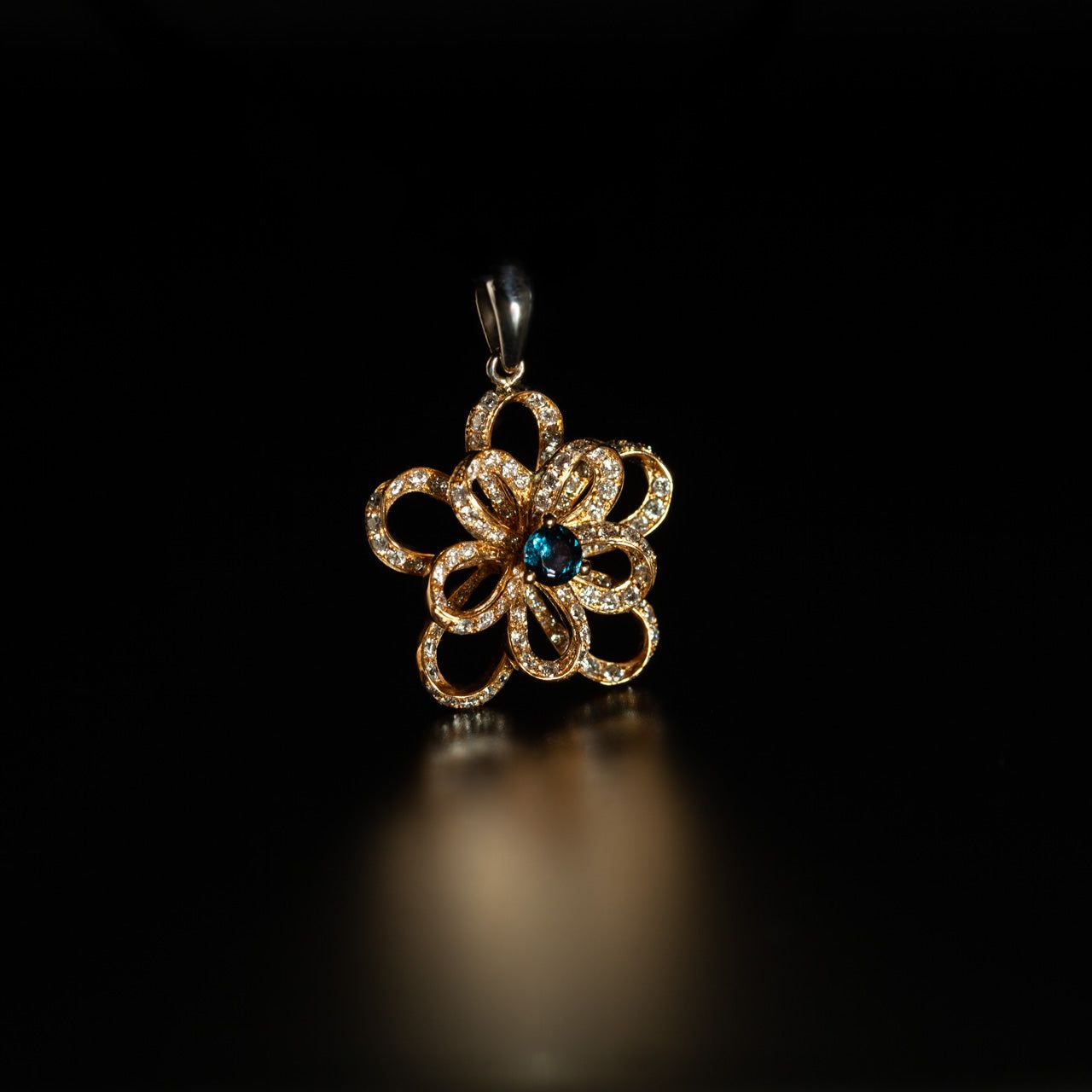Close-up of the 0.18ct natural alexandrite set in an 18k multitone gold flower-designed pendant
