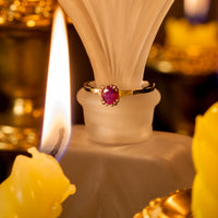 Thumbnail for 0.63ct natural alexandrite platinum ring with oval gemstone and diamond accents displayed near candlelight