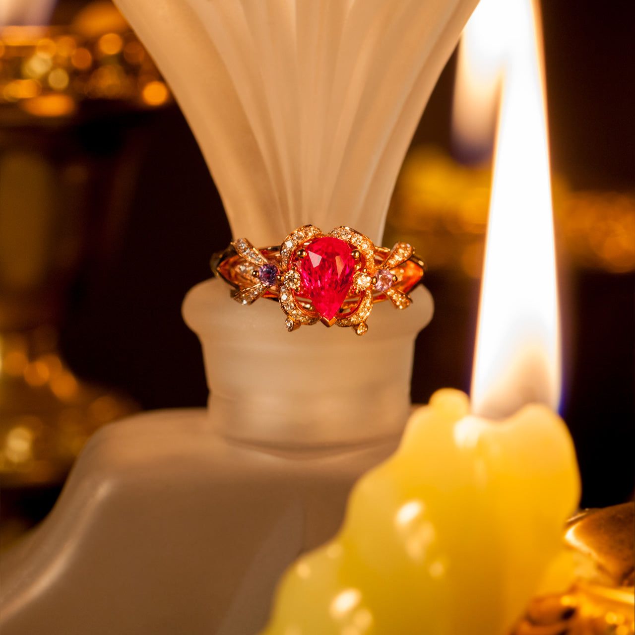 18k rose gold ring featuring a pear-shaped natural ruby and two round natural alexandrites with diamond accents