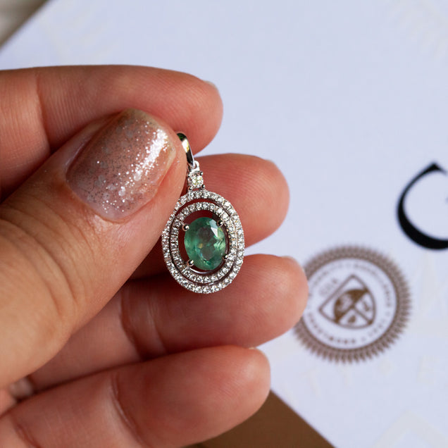 A person showcasing a 1.35ct natural Alexandrite pendant set in 18k white gold