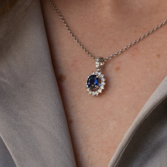 Close-up of a 0.73ct blue sapphire and diamond pendant on a white gold chain