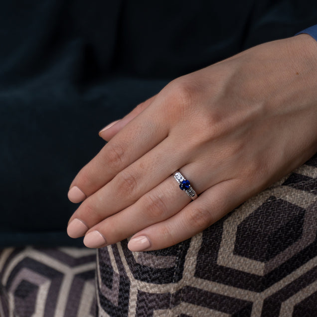 Woman's hand adorned with an 18k white gold ring with a 0.93ct blue sapphire centerpiece