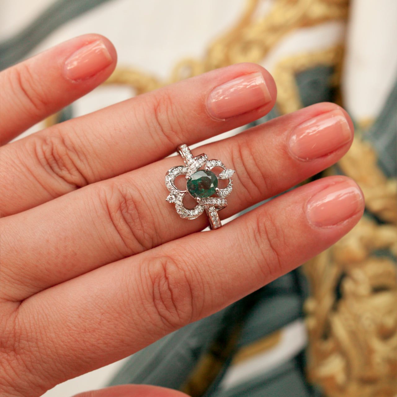 Natural Alexandrite 18k white gold ring with oval green to reddish-purple color-changing gemstone and diamond accents on hand