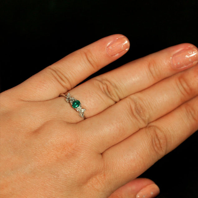 Woman's hand wearing a 0.35ct natural alexandrite ring set in 18K white gold