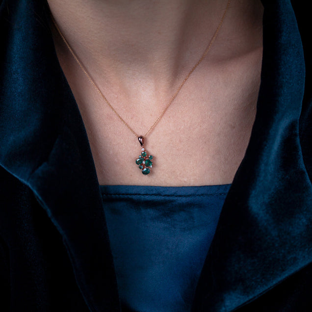 Woman wearing an 18k rose gold necklace featuring a 1.45ctw natural alexandrite pendant