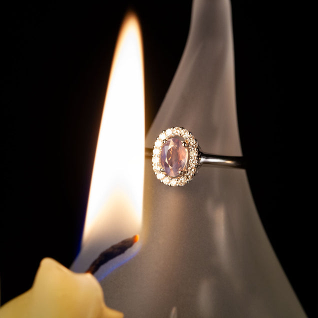 Candlelight illuminating the 0.42ct natural alexandrite on an 18k white gold ring