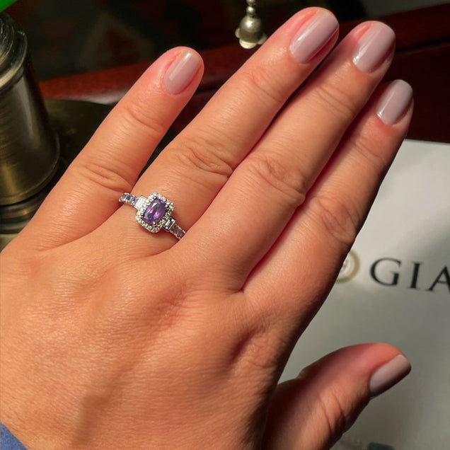 A woman's hand modeling a 0.95ct natural alexandrite ring in an 18k white gold setting