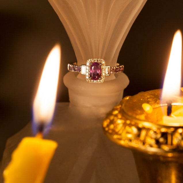 An 18k white gold ring featuring a 0.95ct alexandrite stone next to a candle setting
