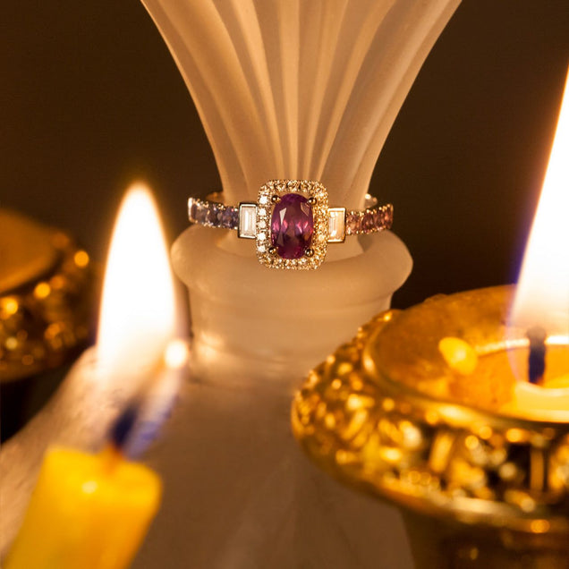 A 0.95ct alexandrite ring in 18k white gold placed atop a candle for display