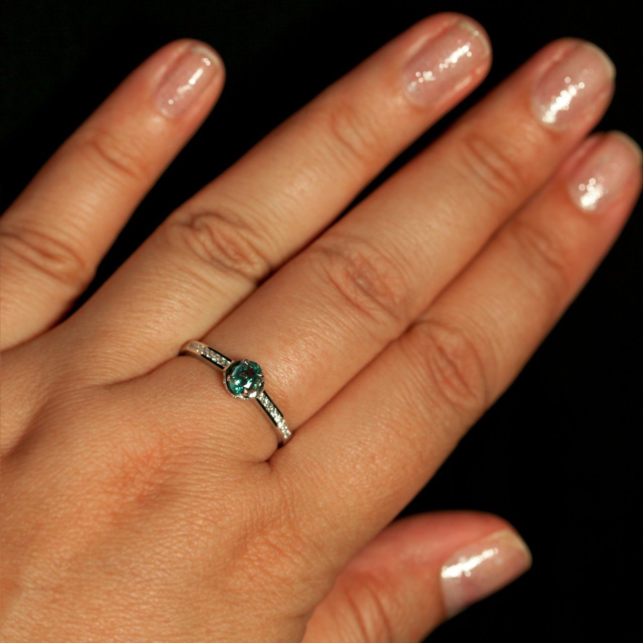 Woman's hand displaying an 18k white gold ring with a 0.55ct alexandrite