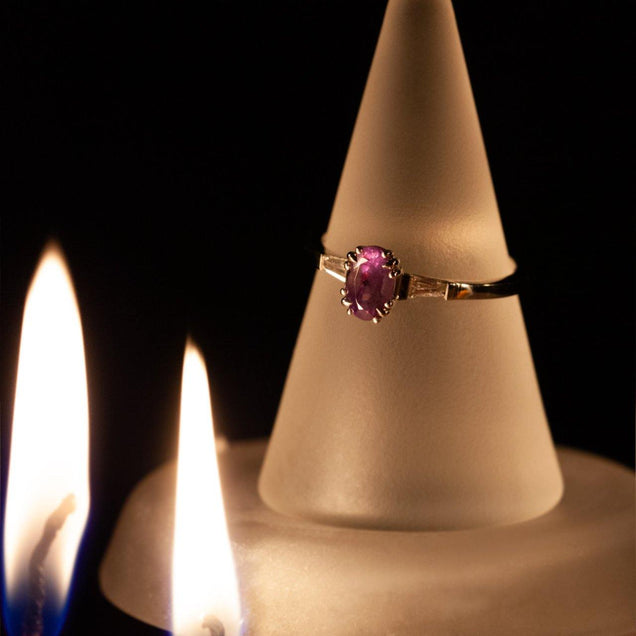 1.23ctw natural alexandrite platinum ring displayed on a candle for ambiance