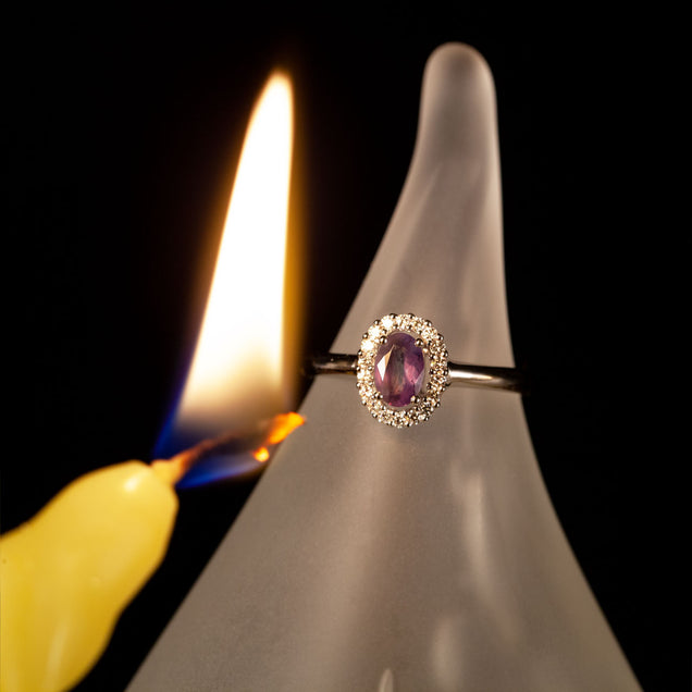 18k white gold ring featuring a 0.45ct natural Alexandrite on a candlelit background