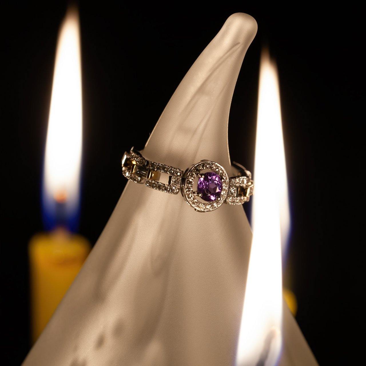 0.40ct alexandrite stone set in an 18k multitone gold ring, displayed on a candle