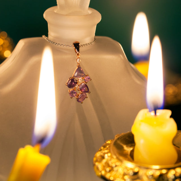 Romantic setting with a candle illuminating the 1.50ctw natural alexandrite in an 18k rose gold pendant