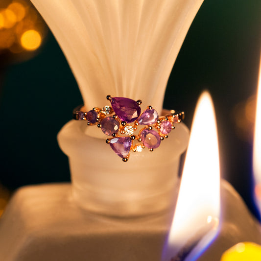 1.70ctw natural alexandrite ring in 18k rose gold resting on a candle base