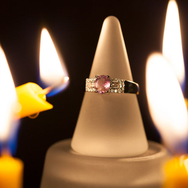 1.22ct natural alexandrite ring in 18k white gold presented on a candle for ambiance
