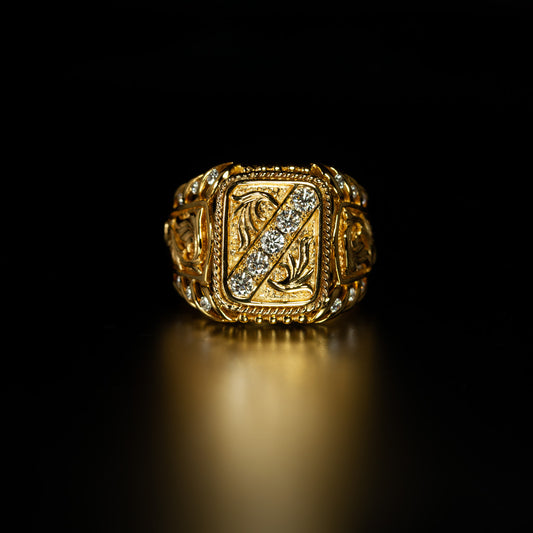 Detailed shot of the 18k yellow gold signet ring's diamond setting