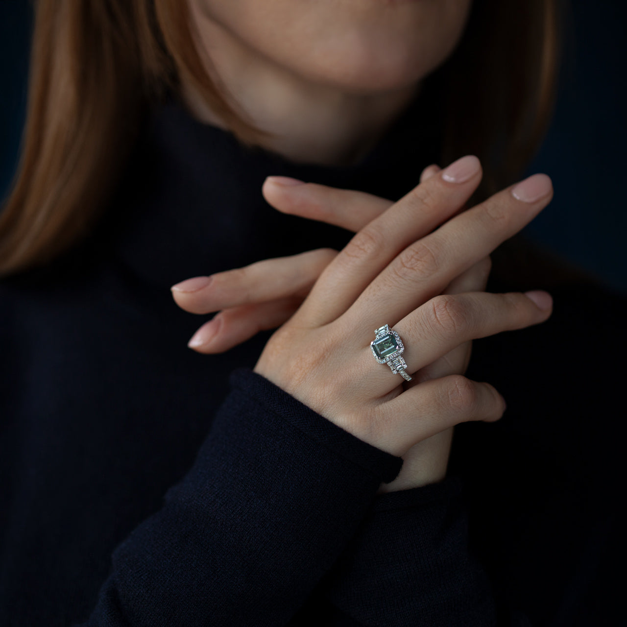 A woman's hand adorned with the 2.23ct alexandrite ring in 18k white gold, showcasing the stone's blue color in different light