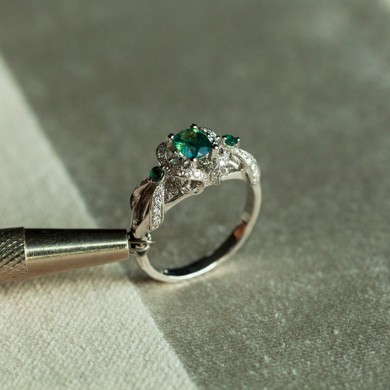 0.65ct natural alexandrite ring in 18k white gold with diamonds and accent stones showcasing color change and vintage design