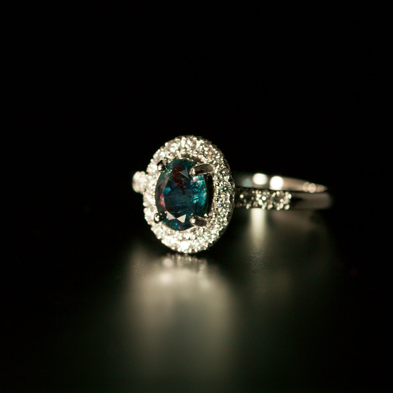 An 0.86ct natural alexandrite ring with a diamond halo in 18k white gold setting
