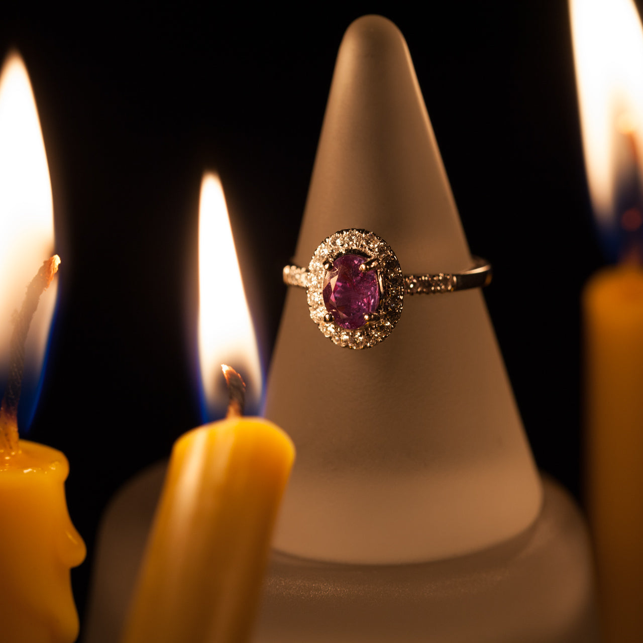 The 0.86ct natural alexandrite ring in 18k white gold showcased on a candle base