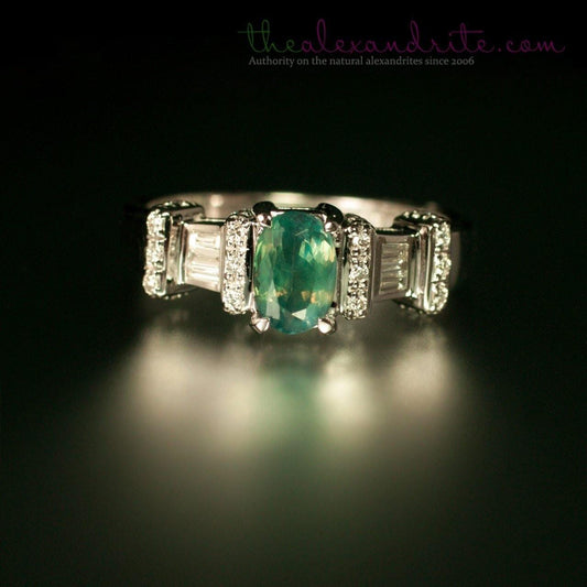 1.11ct natural alexandrite set in 18K white gold ring against a dark backdrop