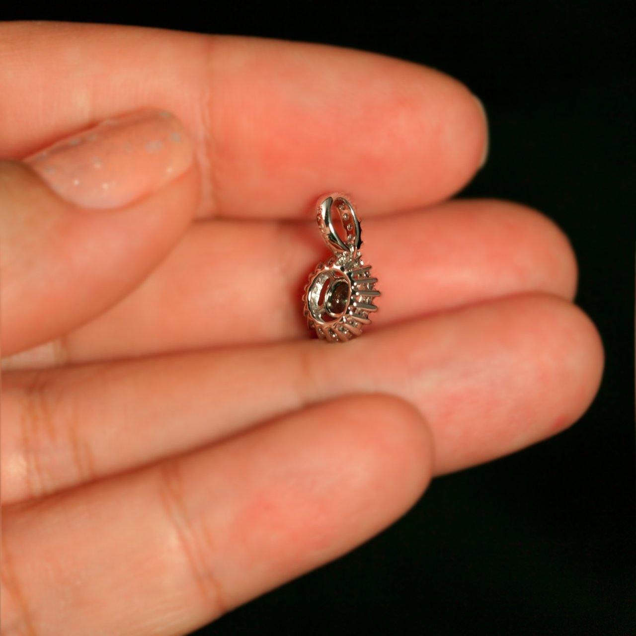 Close-up of a 0.20ct alexandrite pendant in 18k white gold with intricate design