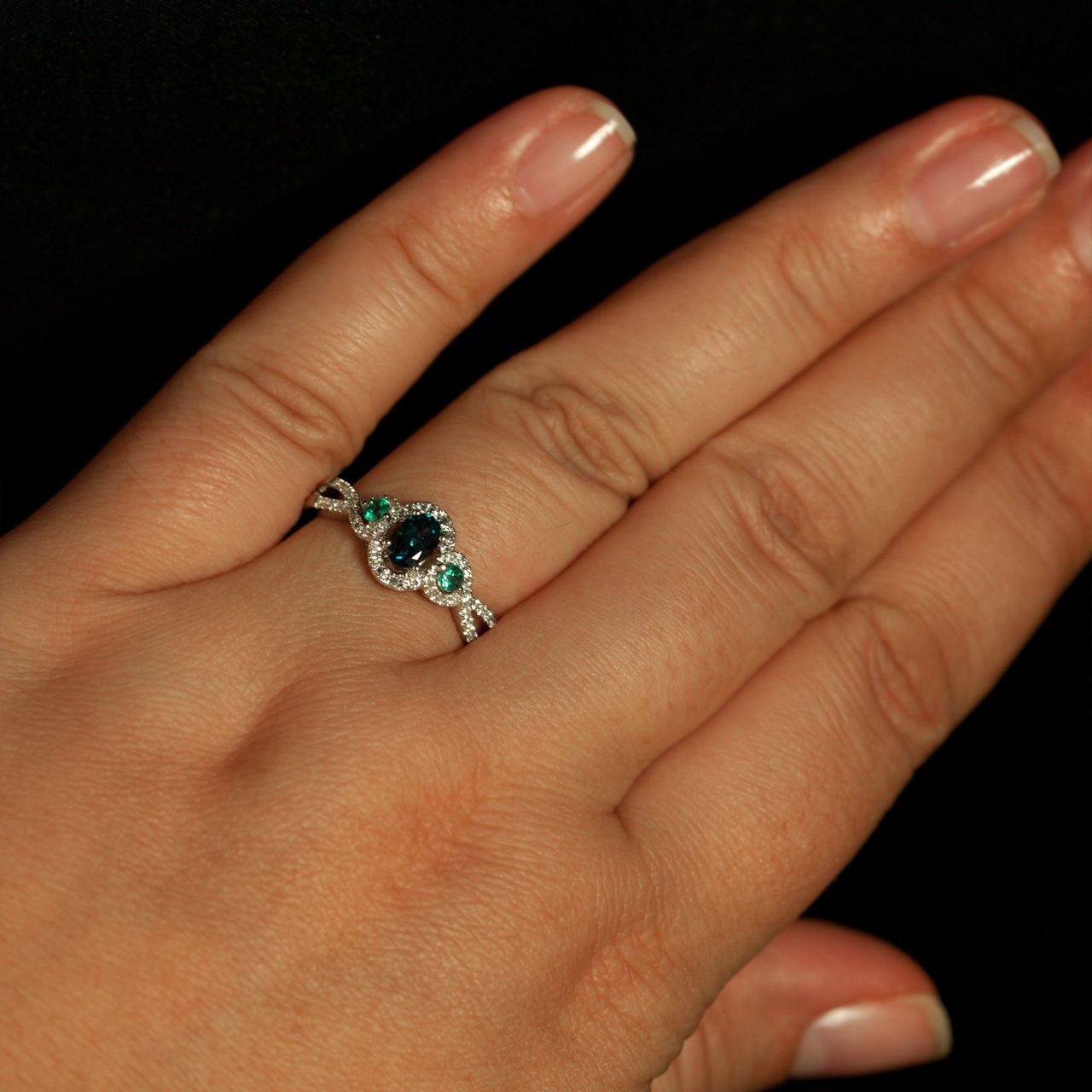 Woman's hand elegantly displaying a 0.42ct natural alexandrite ring in 18k white gold