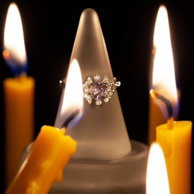 18k white gold ring featuring a 0.68ct natural alexandrite perched on the edge of a candle