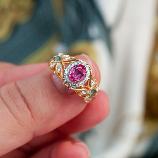 Close-up of a 0.74ct pink sapphire and alexandrite accented ring in an 18k gold setting