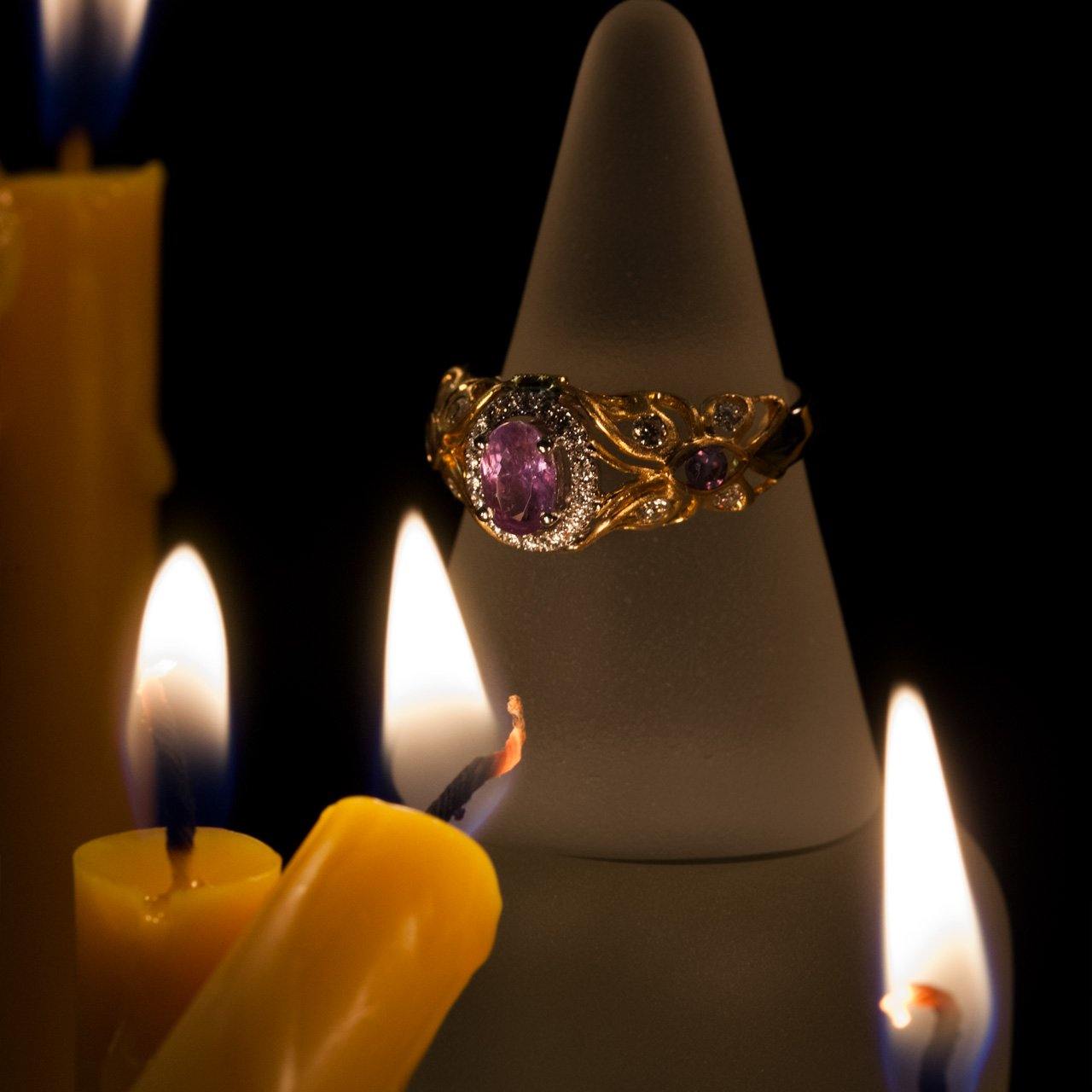 Elegant 0.67ct natural Alexandrite ring in 18k two-tone gold resting on a soft fabric