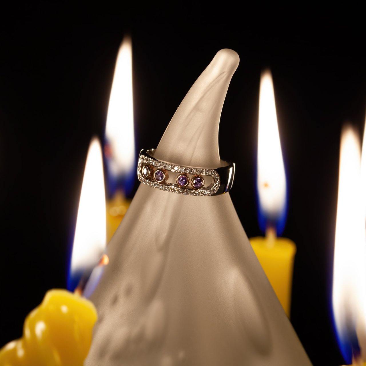 0.22ct natural alexandrite engagement ring in 18k white and rose gold on a candle