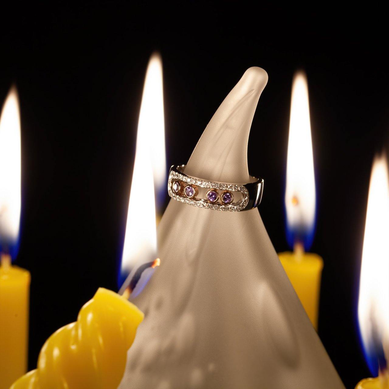 0.22ct natural alexandrite ring on 18k white and rose gold setting displayed on a candle
