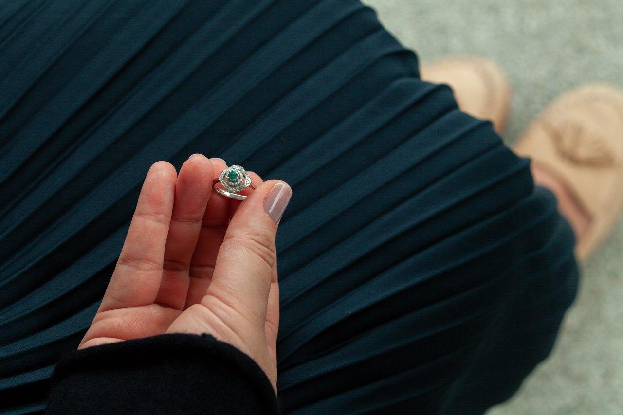 Close-up of a 0.60ct natural alexandrite platinum ring being held by someone