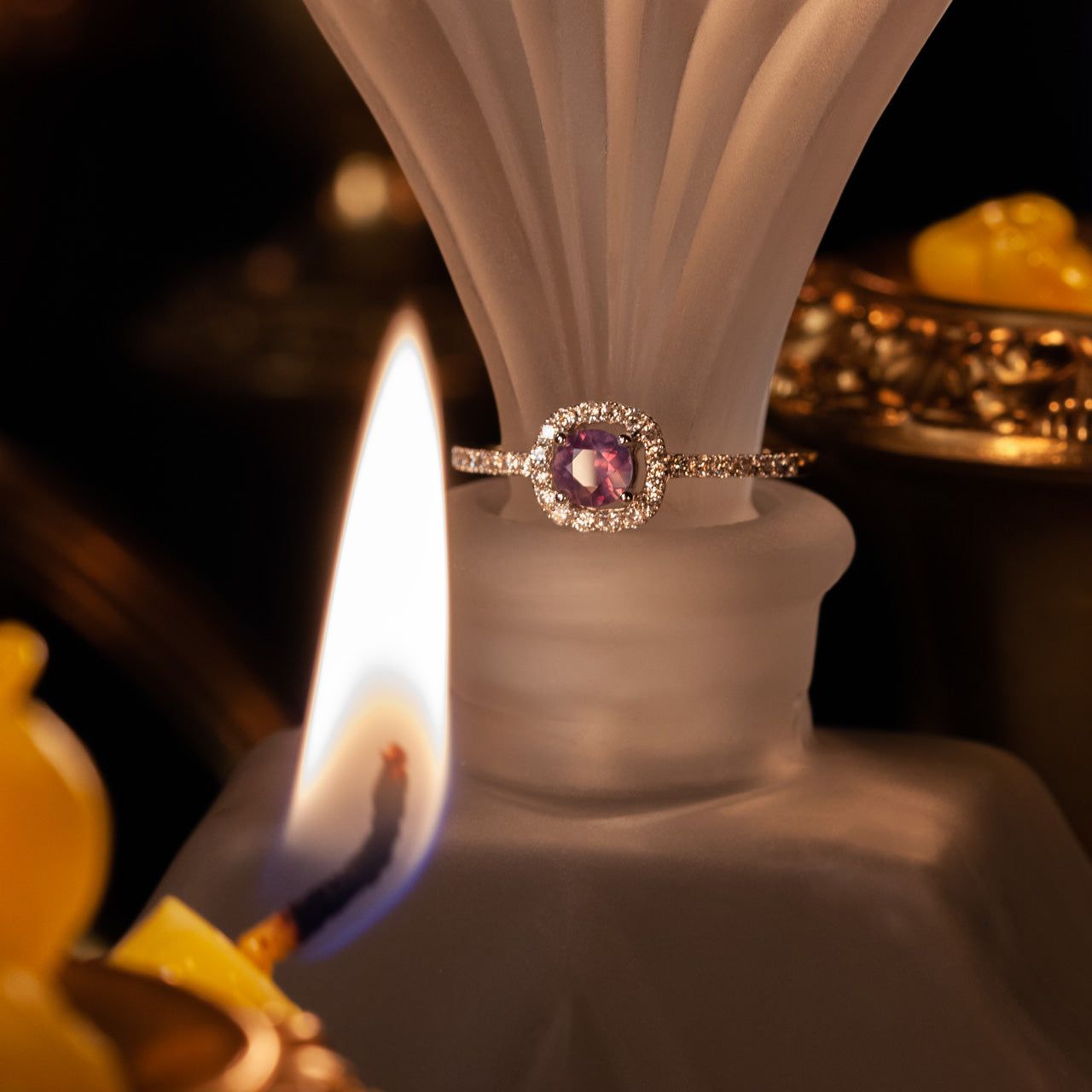 0.45ct alexandrite gemstone in 18k white gold ring showcasing its color shift on candlelight