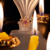 Thumbnail for 0.24ct natural Alexandrite spinner ring in 18k multitone gold displayed beside candles