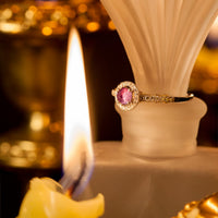 Thumbnail for 0.56ct alexandrite set in an 18k gold ring resting atop a candle