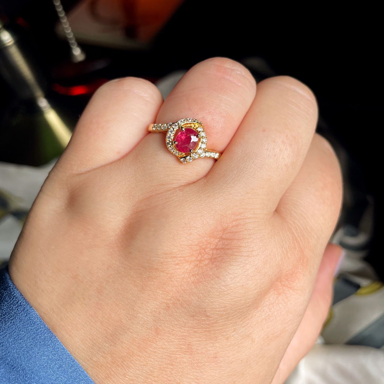 Hand model displaying a 0.54ct ruby ring made of 18k yellow gold
