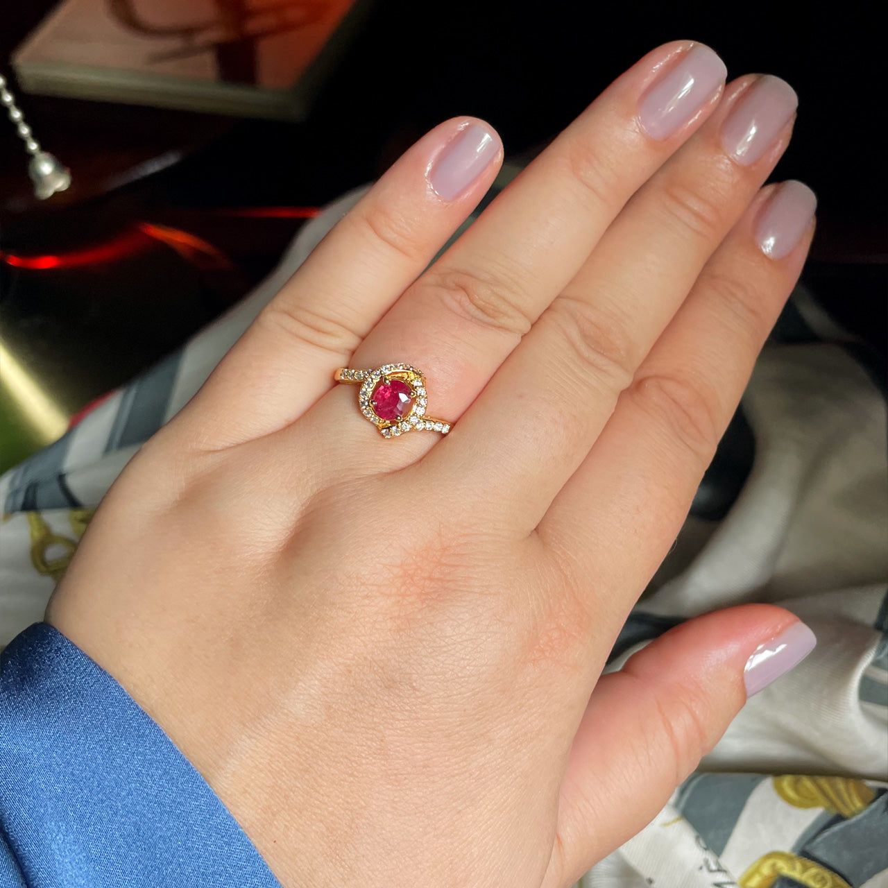 0.54ct unheated ruby ring on a woman's finger with an 18k yellow gold setting