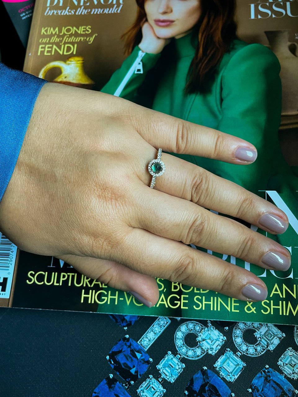 A woman's hand showcasing a 0.56ct alexandrite ring in 18k gold