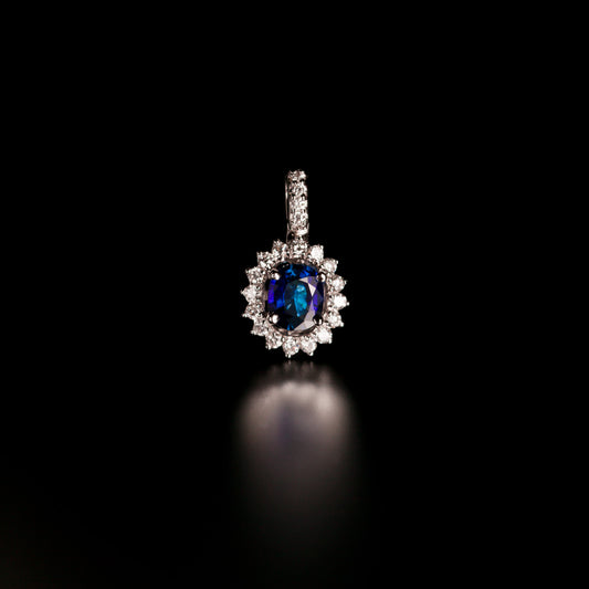 18k white gold pendant featuring a 0.73ct blue sapphire and encrusted diamonds on a display