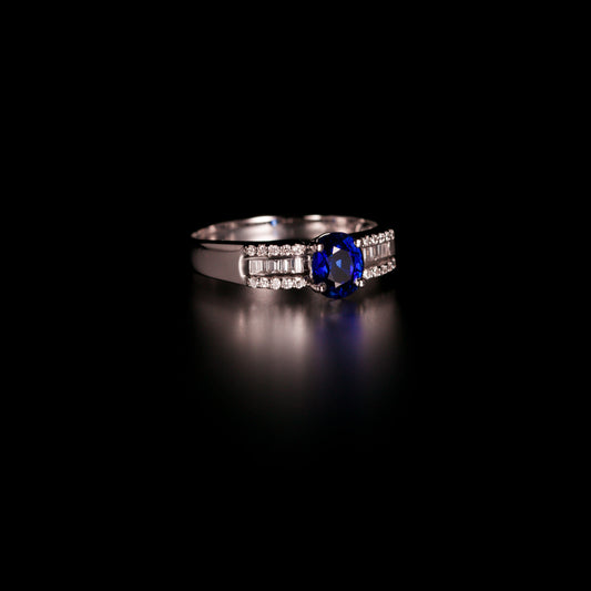0.93ct blue sapphire ring with diamond accents displayed on a dark surface