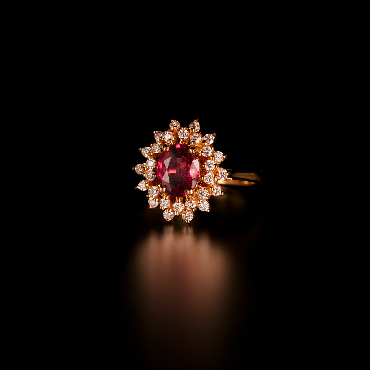 A detailed view of a 1.28ct pink sapphire and diamond ring in an 18k yellow gold setting