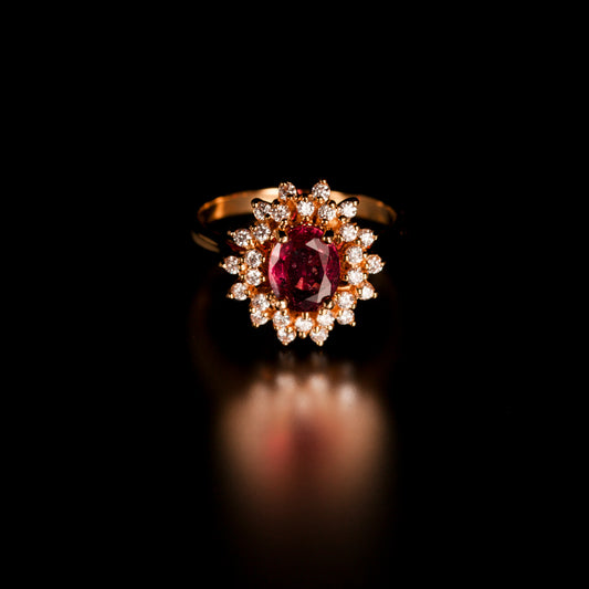 A close-up of a 1.28ct natural unheated pink sapphire ring with 18k yellow gold band