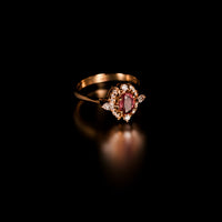 Thumbnail for 0.76ct natural unheated pink sapphire ring in 18k yellow gold with diamond accents on black background