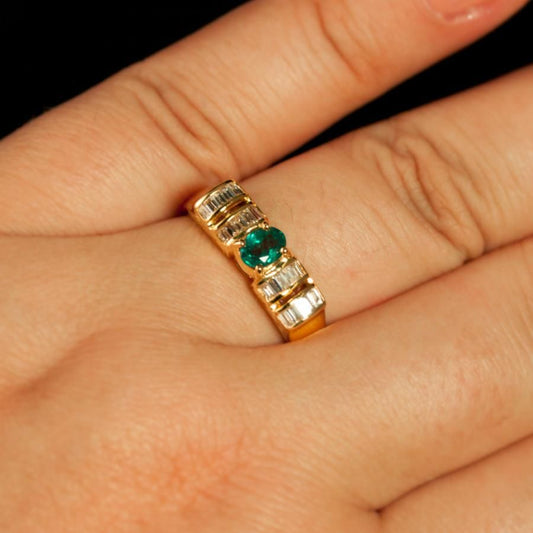 A woman's hand displaying a 0.37ct natural alexandrite ring set in 18k yellow gold
